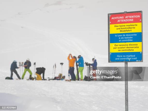 backcountry skiiers getting ready - schild schweiz stock-fotos und bilder