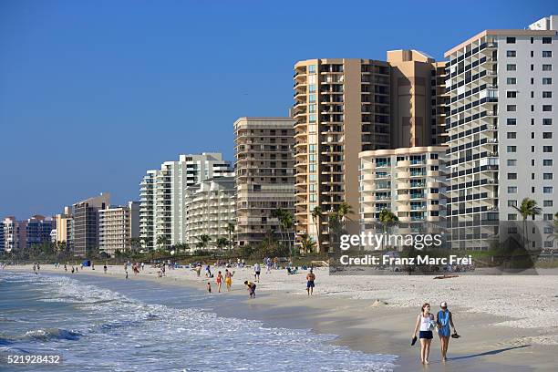 tourists walking on beach on marco island - marco island stock-fotos und bilder