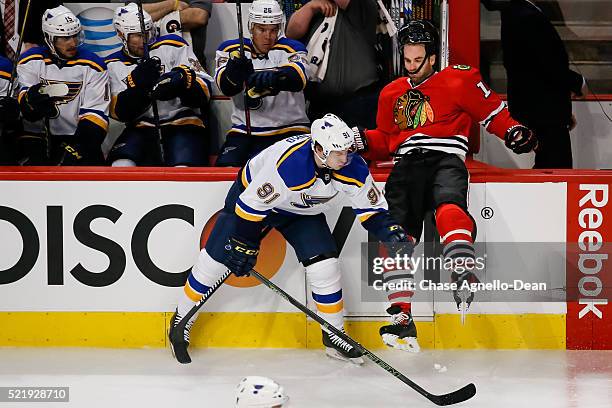 Vladimir Tarasenko of the St. Louis Blues pushes Andrew Ladd of the Chicago Blackhawks into the boards in the first period of Game Three of the...