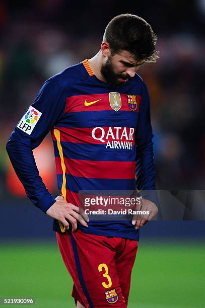 Gerard Pique of FC Barcelona leaves the pitch dejected at the end of the La Liga match between FC Barcelona and Valencia CF at Camp Nou on April 17,...
