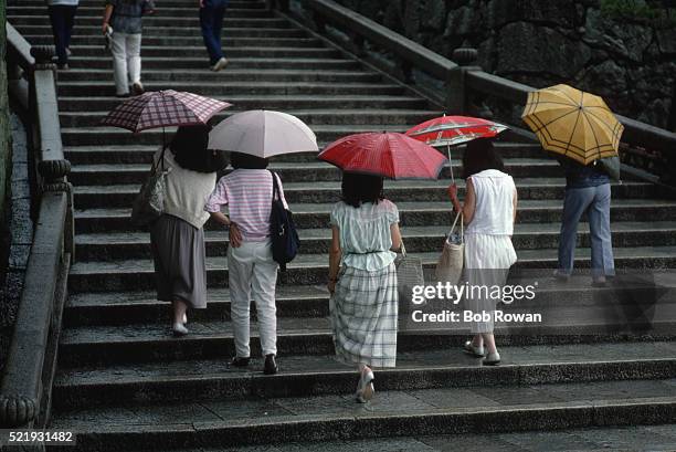 women walking under umbrellas - showa period fotografías e imágenes de stock