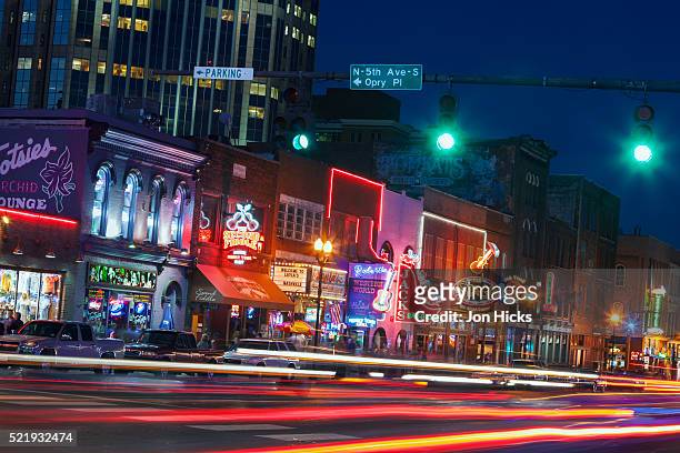 nashville's broadway at night - country and western music stock pictures, royalty-free photos & images