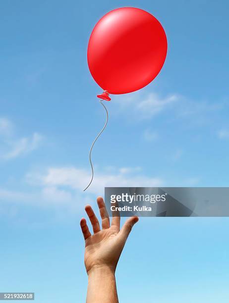 hand reaching up to balloon - releasing stock pictures, royalty-free photos & images