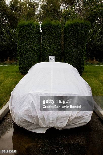 covered car in parking spot with r.i.p. sign - plane stock-fotos und bilder