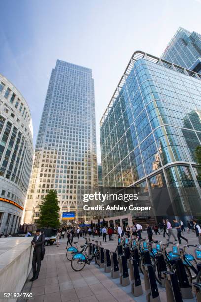 banks in canary wharf, london, uk, with a barclays bike hire stand. - barclays cycle hire stock pictures, royalty-free photos & images