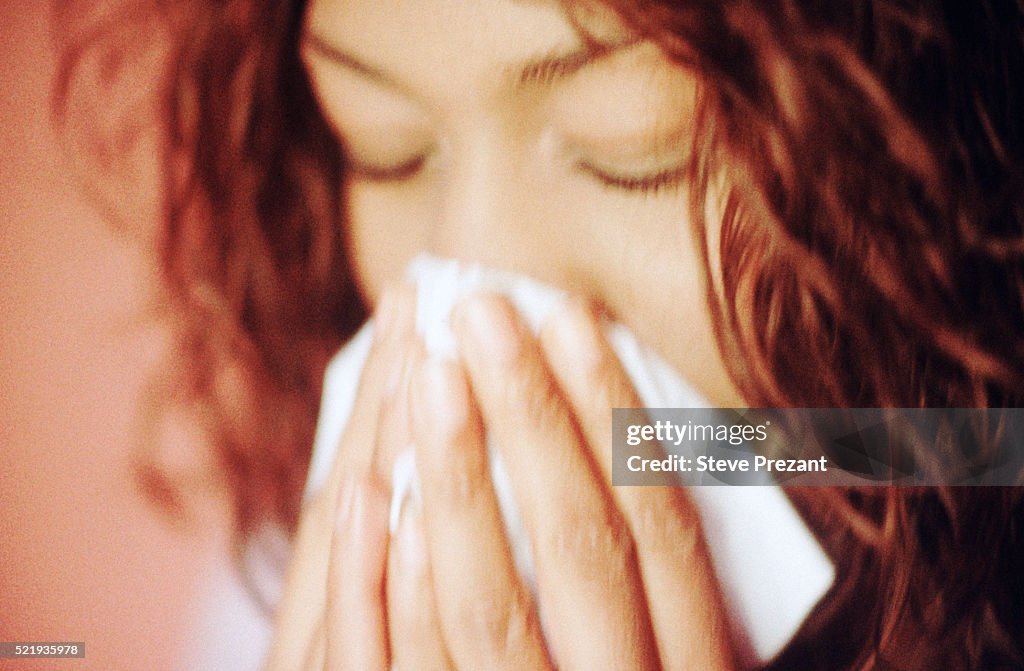 Young Woman Blowing Her Nose