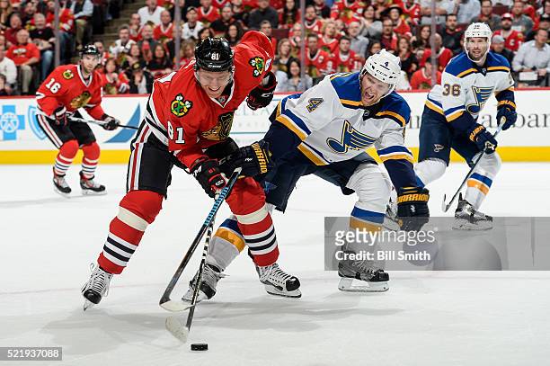 Marian Hossa of the Chicago Blackhawks and Carl Gunnarsson of the St. Louis Blues chase the puck in the first period of Game Three of the Western...