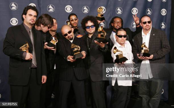 Ozomatli pose backstage with their award for "Best Latin Rock/Alternative Album" during the 47th Annual Grammy Awards at the Staples Center February...