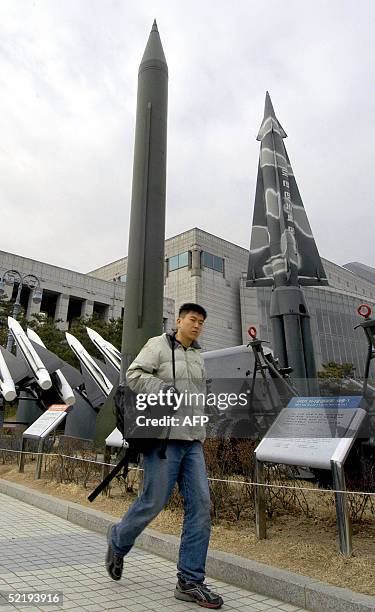 Man walks past a row of scraped missiles on display at the war museum in Seoul, 14 February 2005, including a South Korean Nike missile and a North...