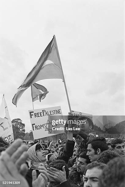 Eight year old Tariq Attia is hoisted above the crowd as Fatah supporters demonstrate against Israel, 2nd November 1969.