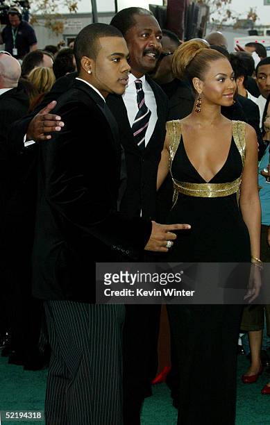 Singer Beyonce Knowles and her father Mathew Knowles pose for a picture with Singer Mario as they arrive to the 47th Annual Grammy Awards at the...