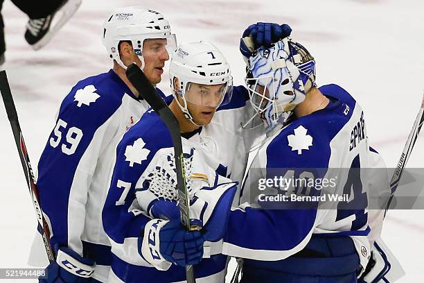 Marlies' Willie Corrin and Eric Faille ( centre congratulate goalie Garret Sparks after winning 4-2 in AHL action between the Toronto Marlies and...