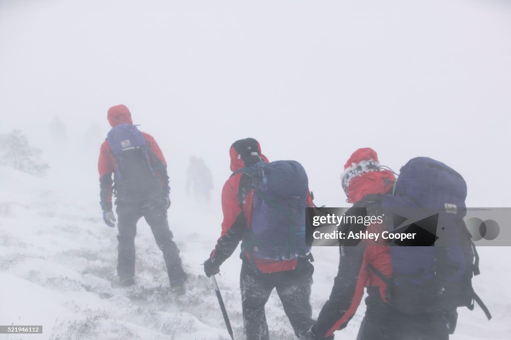 Mountain Climbers Hiking Through a Blizzard