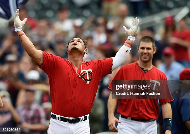 Joe Mauer of the Minnesota Twins looks on as teammate Oswaldo Arcia celebrates a walk-off single against the Los Angeles Angels of Anaheim during the...