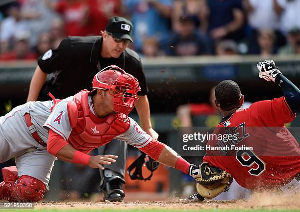 Carlos Perez of the Los Angeles Angels of Anaheim defends home plate against Eduardo Nunez of the Minnesota Twins during the seventh inning of the...