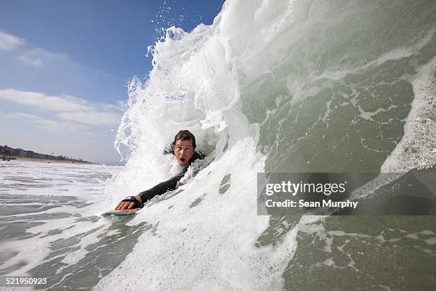 man body surfing on a hand plane - hochgefühl stock-fotos und bilder