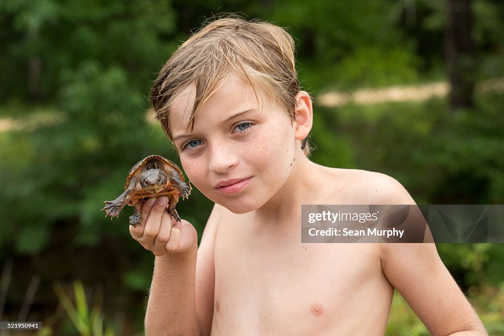 Young Boy Holding Mud Turtle