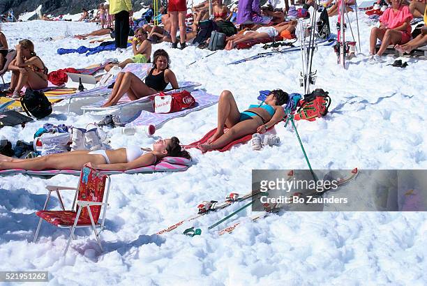 sunbathing on snow - sports archive stockfoto's en -beelden