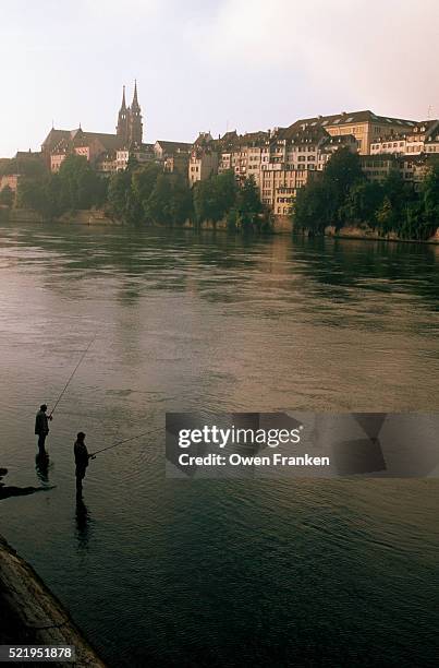 men fishing on the rhine river - basel stockfoto's en -beelden