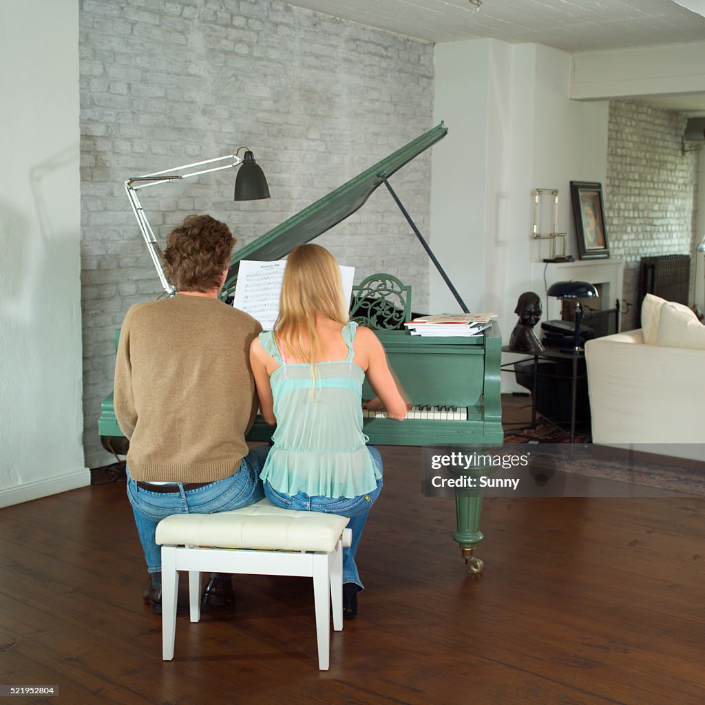 Young Couple Playing Piano