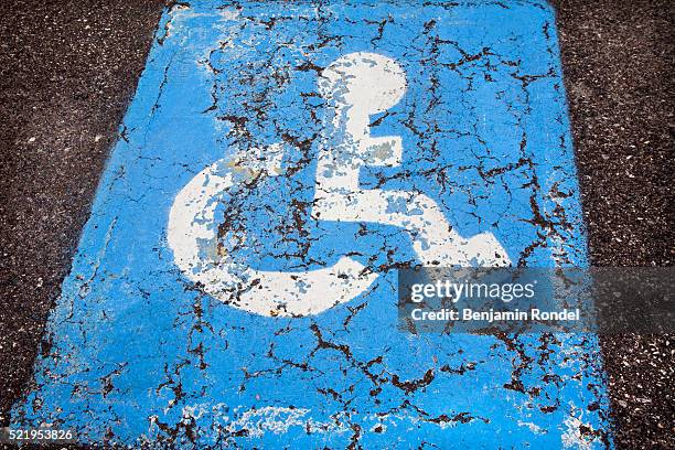 handicapped parking sign painted on cement - handicap parking space stock pictures, royalty-free photos & images