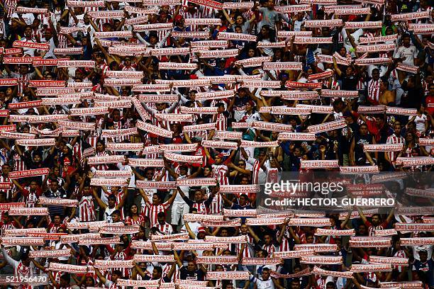 Fans of Guadalajara cheer for their team during the 2016 Mexican Clausura football tournament match against Atlas, at Chivas' stadium in Guadalajara,...