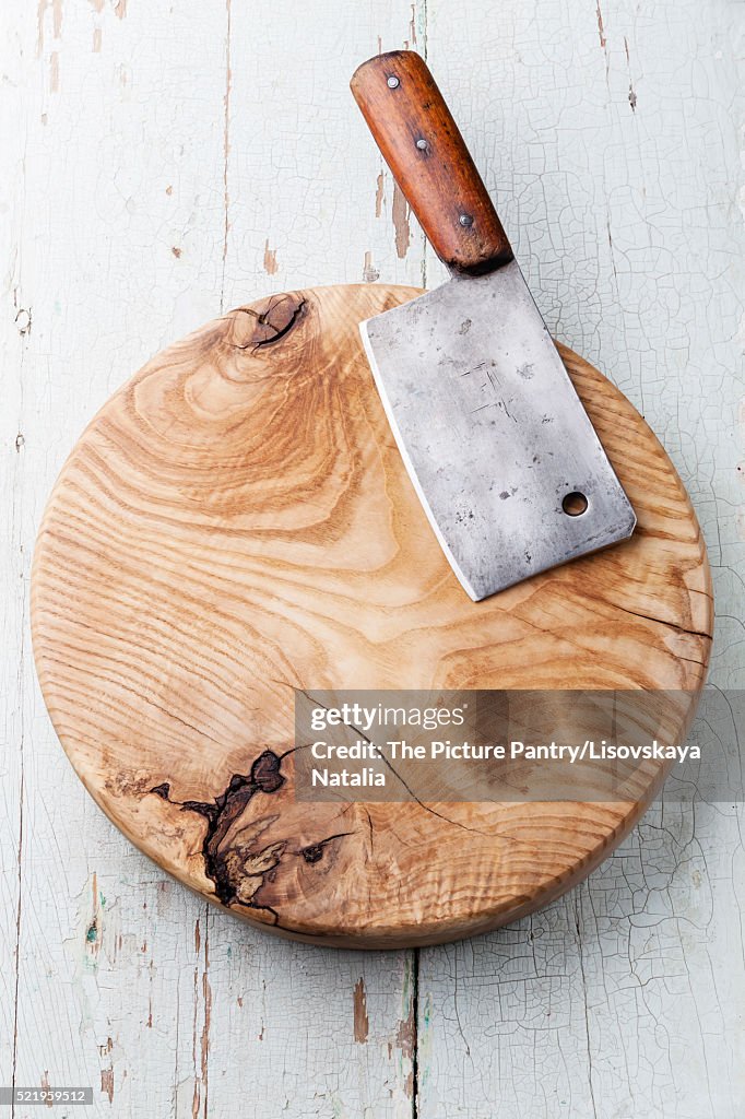 Meat cleaver on blue wooden background