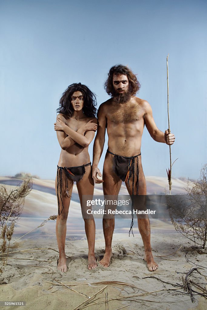 Prehistoric man and woman next to each other