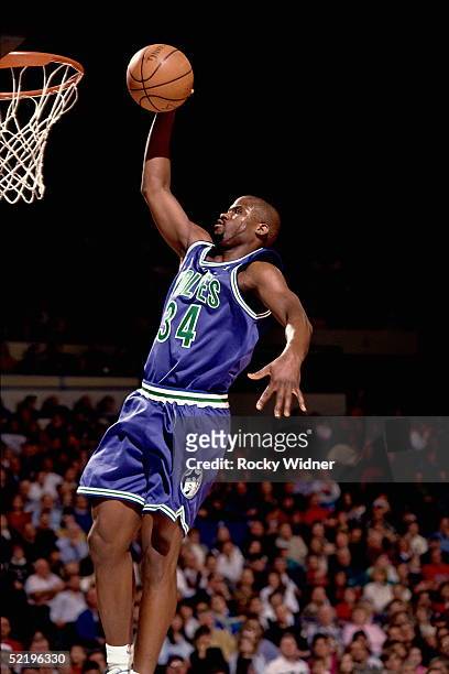 Isaiah Rider of the Minnesota Timberwolves goes up for a slam dunk against the Sacramento Kings during an NBA game circa 1994 at the Arco Arena in...