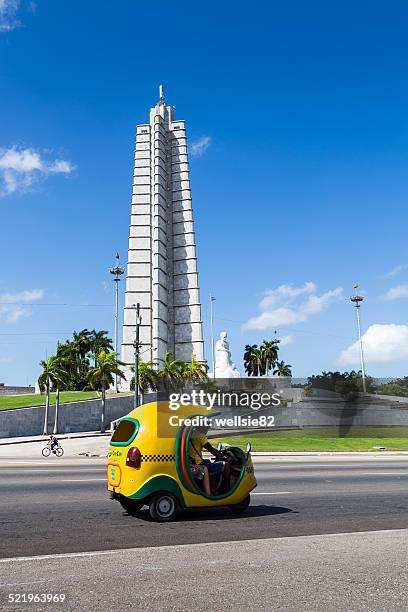 cocotaxi passes the jose marti memorial - cuba monument stock pictures, royalty-free photos & images