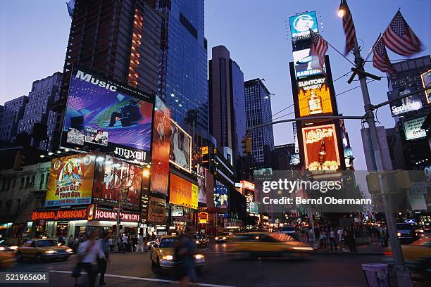 times square at dusk - taxi logos stock pictures, royalty-free photos & images