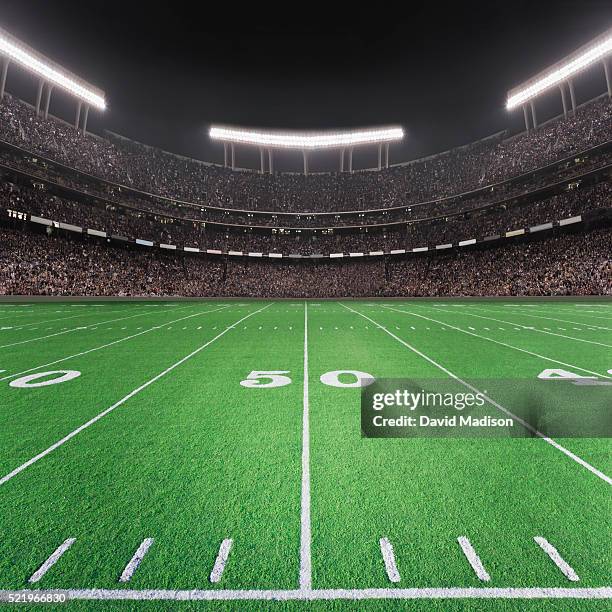 american football stadium, 50 yard line view - stadion flutlicht stock-fotos und bilder