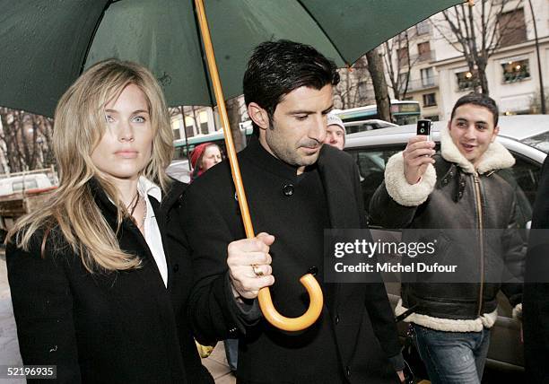 Portugese footballer Luis Figo and wife Helena leave their Paris hotel, The Plaza, to attend Real Madrid teammate Ronaldo's engagement party at...