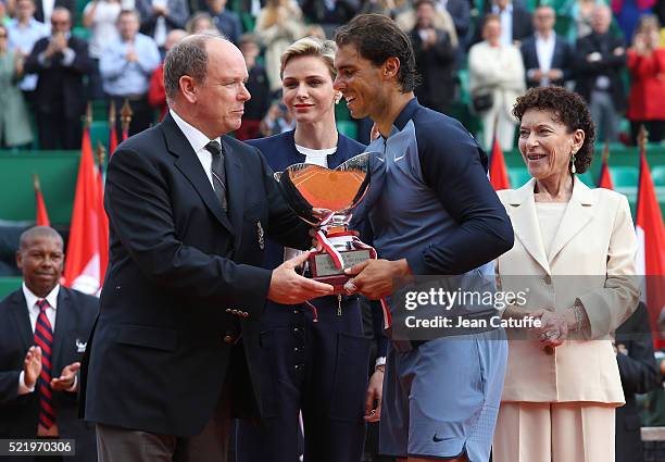 Rafael Nadal of Spain is presented with the trophy by Prince Albert II of Monaco, Princess Charlene of Monaco and Elisabeth Anne de Massy after...