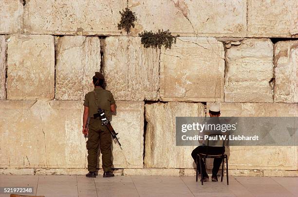 men praying at the western wall of temple mount - kippa stock pictures, royalty-free photos & images