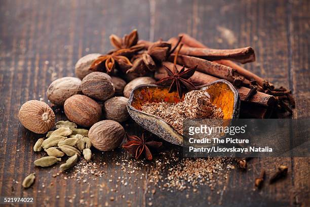 mix of spices nutmeg, cinnamon, star anise, cloves, cardamom - natalia star stock pictures, royalty-free photos & images
