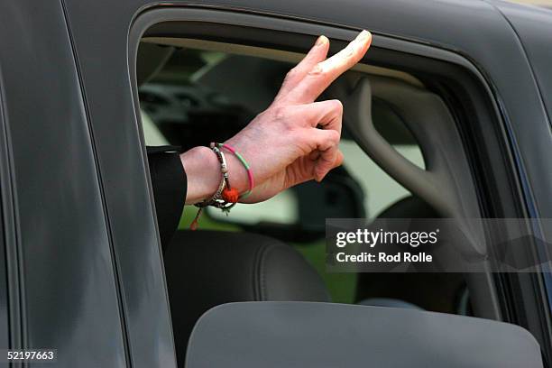 Singer Michael Jackson waves to fans from his Suburban as he departs the Santa Barbara Superior courthouse parking lot February 14, 2005 in Santa...