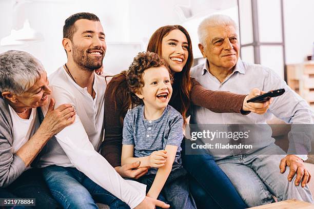 family watching tv - loving 2016 film stock pictures, royalty-free photos & images