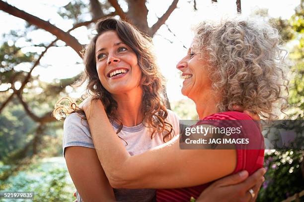 mother and daughter enjoying nature - older woman with brown hair stockfoto's en -beelden