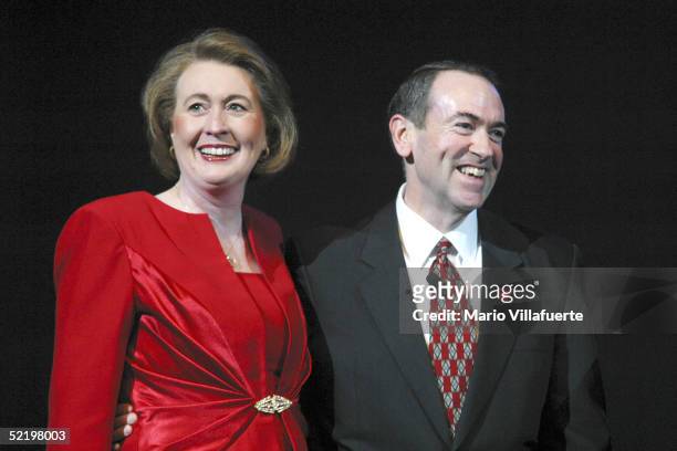 Arkansas Governor Mike Huckabee and his wife, Janet, smile after converting their 30 year marriage to a covenant marriage before several thousand...