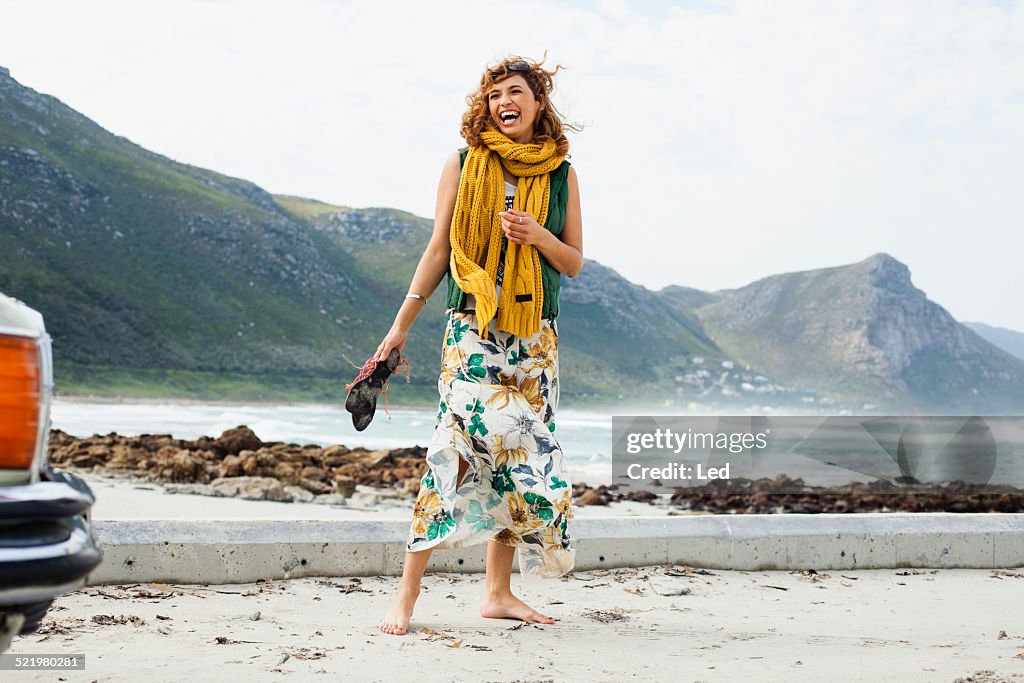 Young woman laughing on beach, Cape Town, Western Cape, South Africa