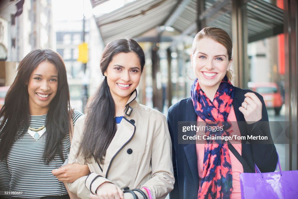 Women walking down city street together