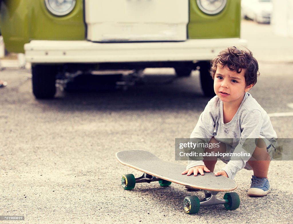 Child with skateboard and van