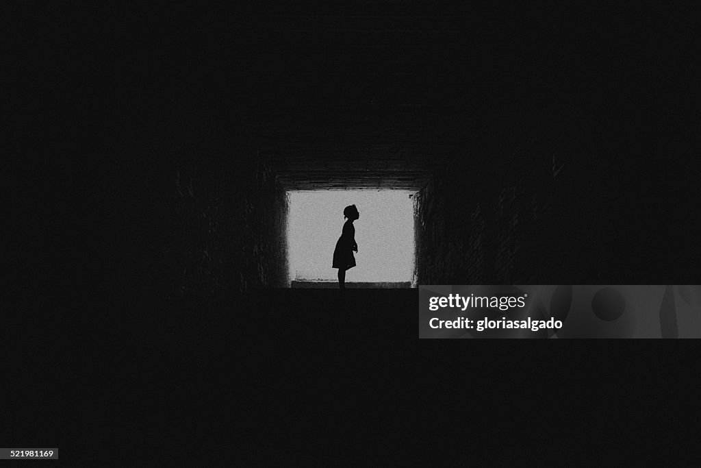 Silhouette of girl through a square window
