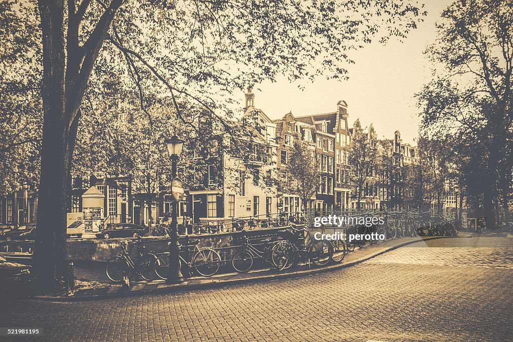 Netherlands, Amsterdam, Bicycles parked along canal railing