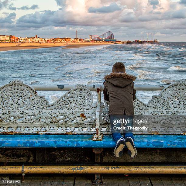 uk, blackpool, boy looking at beach - blackpool stock pictures, royalty-free photos & images