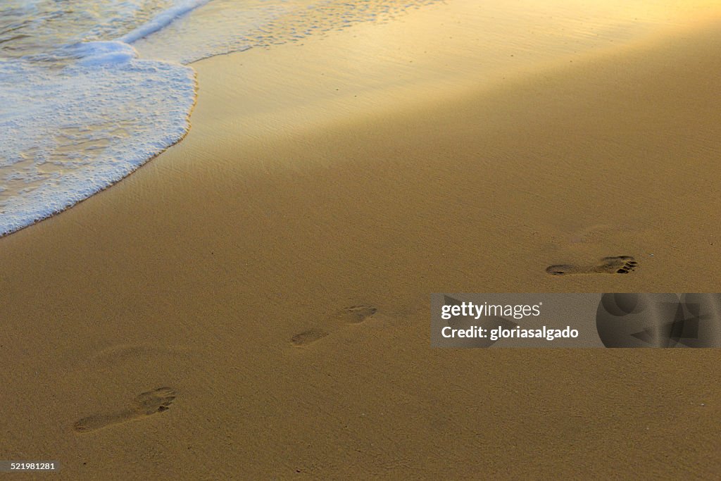 Footprints in sand on beach