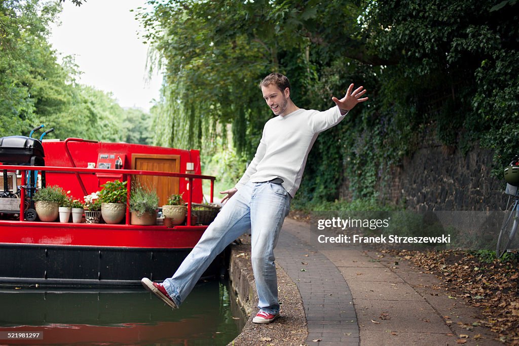 Man pretending to fall into canal , East London, UK