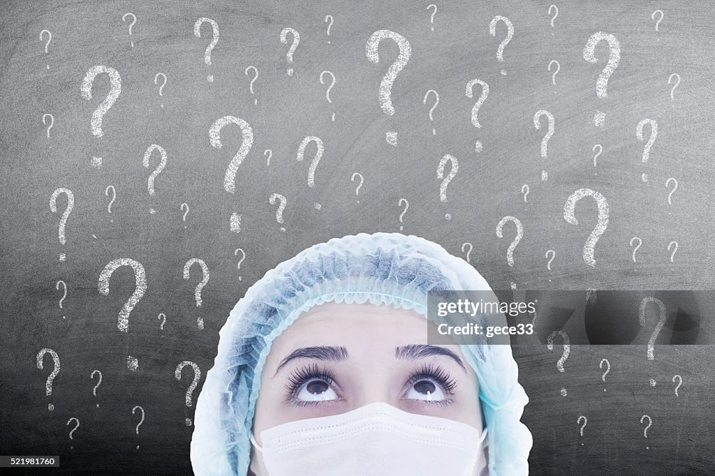 Woman doctor thinking on blackboard