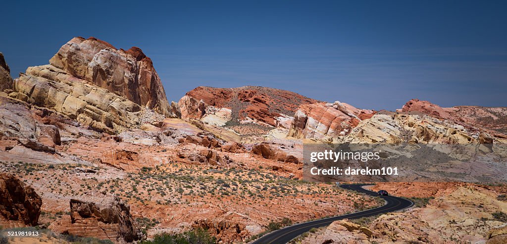 USA, Nevada, Clark County, Lone car on curved road in Valley or Fire State Park